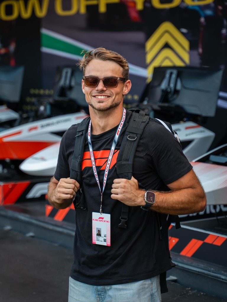 Guest at a motorsport event wearing a paddock pass